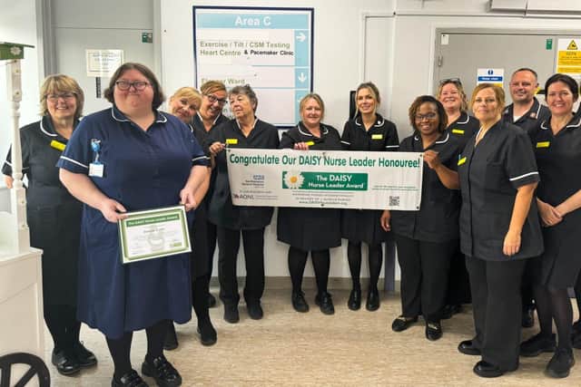 Debbie Curtis, Ward Manager of Allebone Ward with her DAISY leader Award and her ward team