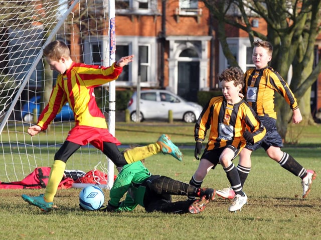 Youth Football action on the Racecourse as FFA (yellow and red) play Parklands Tigers (yellow and black) on December 16 2012.