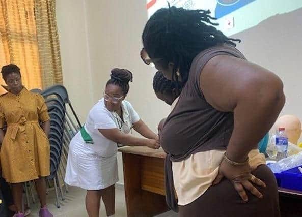Eunice teaching tracheostomy care to nurses at Korle Bu Teaching Hospital