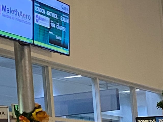 Airport boarding screen showing the Maleth Aero flight chartered by P&O was going to fly back to England at Gatwick Airport from 5.30am.