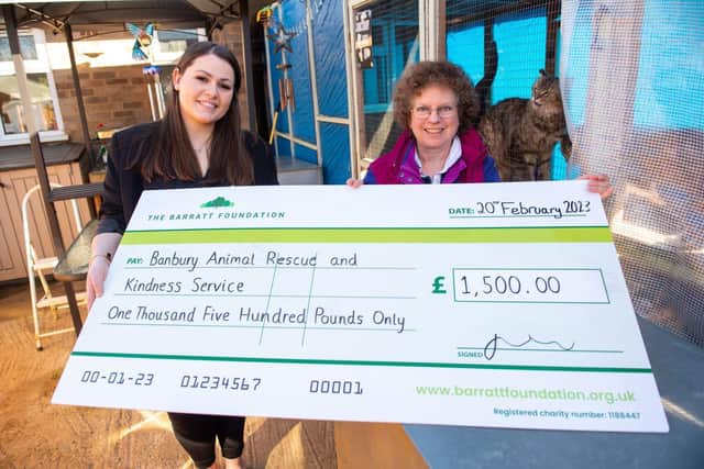 Sarrah Greenall from Barratt Homes presenting a cheque to Ann from BARKS