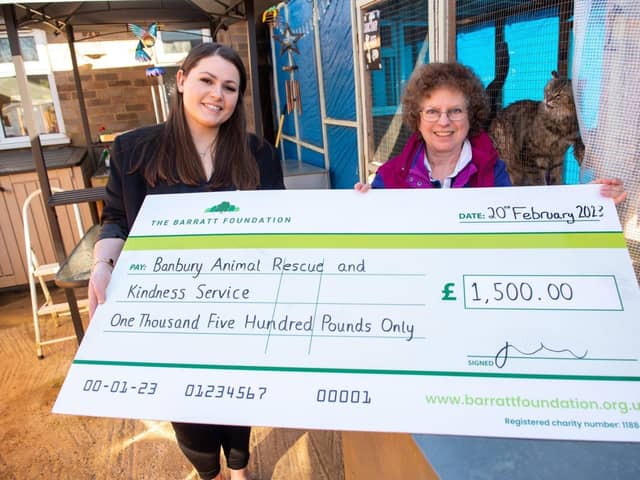 Sarrah Greenall from Barratt Homes presenting a cheque to Ann from BARKS