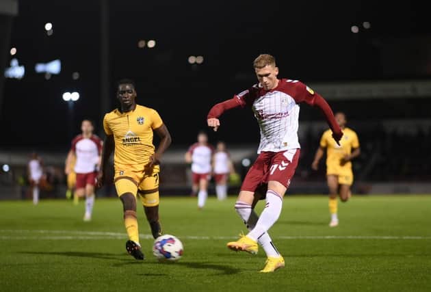 Mitch Pinnock slams home to double Cobblers' lead. Picture: Shaun Botterill/Getty Images.