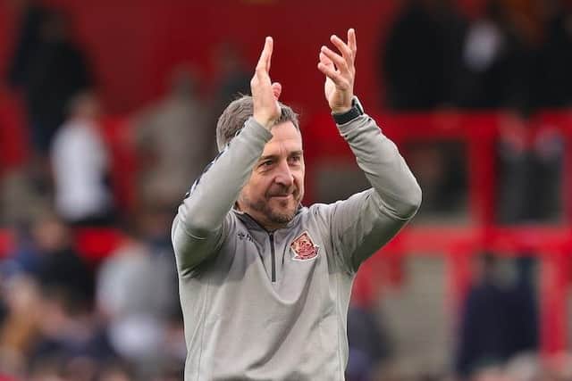 Jon Brady applauds the travelling supporters at Stevenage.