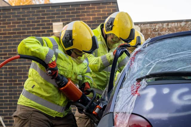 Two firefighters taking part in an RTC drill
