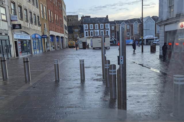 The new Market Square has Hostile Vehicle Mitigation bollards installed, which only allow one vehicle on at a time. There is signage to indicate this, but it is very small.