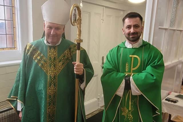 Bishop David and Father Gregory greet parishioners at Holy Trinity