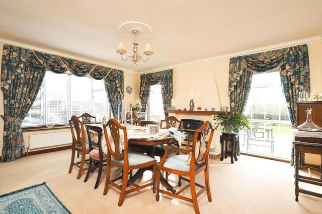 Imagine entertaining friends in this majestic dining room. Windows to the side and rear of the property give plenty of light and offer stunning views, while a gas fire has a feature surround. Next door is a cloakroom, with low-flush WC, a wash hand basin and built-in storage space.