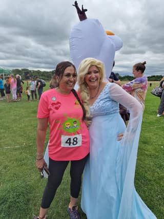 Jemma (left) volunteering as Queen Elsa at the Lewis Foundation water dash 2024 which CLICK was a headline sponsor for.