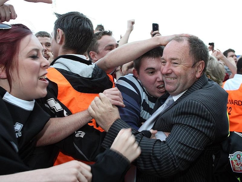 Northampton Town manager Gary Johnson is mobbed by fans after his team avoided relegation at the end of the npower League Two match between Northampton Town and Stevenage at Sixfields Stadium on April 30, 2011.
