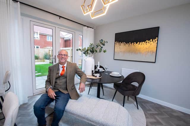 John Lewis sitting in the dining room of his Bellway home
