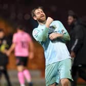 Lee Burge celebrates in front of the travelling fans at Valley Parade.