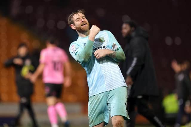 Lee Burge celebrates in front of the travelling fans at Valley Parade.