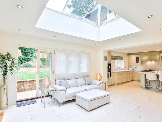 This modern family home is in a picturesque village and shares its boundary with a church.