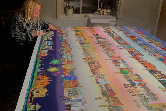 Artist inspects town mural