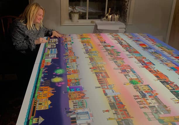 Artist inspects town mural