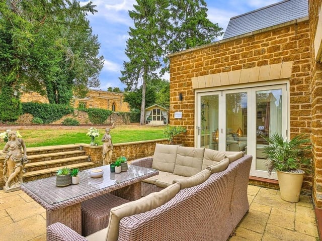This modern family home is in a picturesque village and shares its boundary with a church.