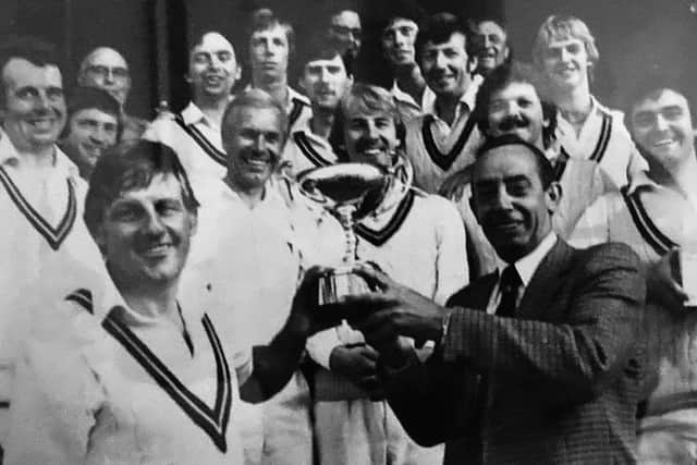 Lynn Wilson accepts the 1980 Manns Cup after Saints' final victory
