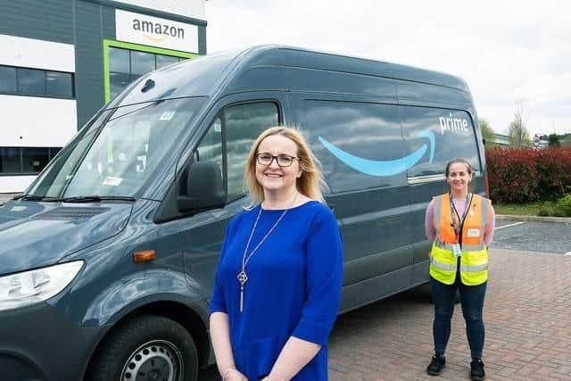 Library picture showing Tessa Taylor, from KidsAid, pictured with Amazon operations manager, Verity Barber, from last year when Amazon donated £1,000 from the team at the delivery station team in Northampton