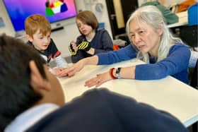 Senior Lecturer in Psychology Jo Chen Wilson helps students from Kingsley Primary 