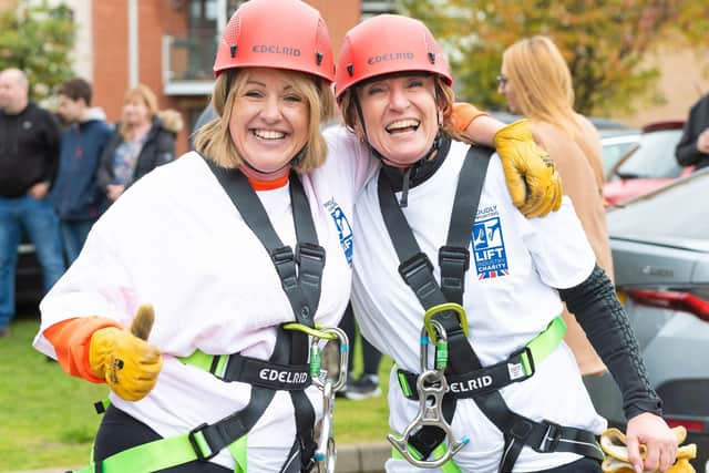 Photographed are participants of the Lift Tower abseil.