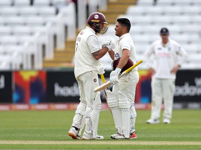 Ricardo Vasconcelos is congratulated by skipper Luke Procter after reaching three figures at Durham