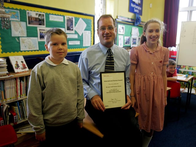 2006: St. Lois Primary School - Head Teacher Rob Hazelgrove with head boy and girl Phillip Lambert and Sophie Bird with international school award