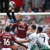 Sam Sherring challenges for the ball during the Cobblers' Sky Bet League One clash with Lincoln City at Sixfields on Tuesday night (Picture: Pete Norton)