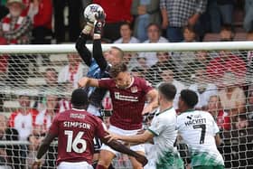 Sam Sherring challenges for the ball during the Cobblers' Sky Bet League One clash with Lincoln City at Sixfields on Tuesday night (Picture: Pete Norton)