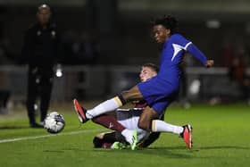 Harvey Lintott goes sliding in with Chelsea's Reiss Alexander Russell-Denny during Tuesday's EFL Trophy match at Sixfields. (Photo by Pete Norton/Getty Images)