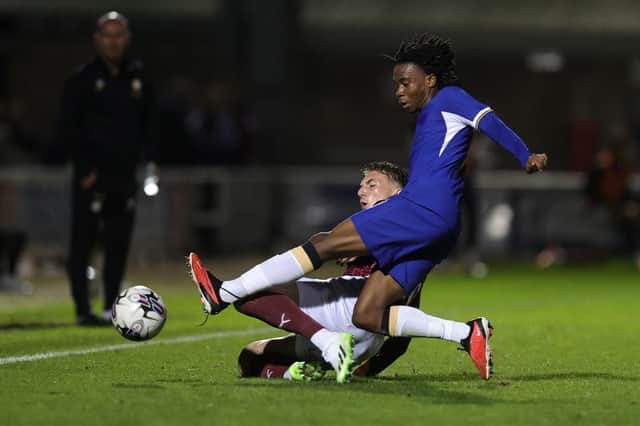 Harvey Lintott goes sliding in with Chelsea's Reiss Alexander Russell-Denny during Tuesday's EFL Trophy match at Sixfields. (Photo by Pete Norton/Getty Images)