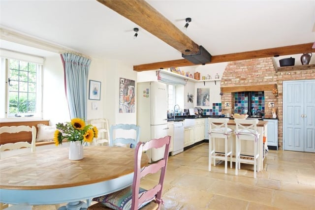 The home has extensive accommodation, ideal for entertaining, as well as traditional features such as ceiling beams and exposed brick.