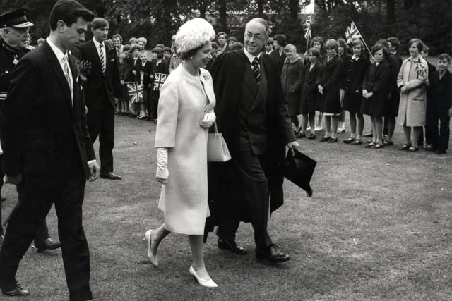 The Queen walks in the grounds of Wellingborough School with headmaster Mr Sugden during royal visit on July 9, 1965