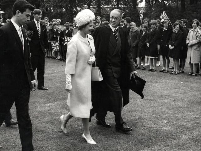 The Queen walks in the grounds of Wellingborough School with headmaster Mr Sugden during royal visit on July 9, 1965