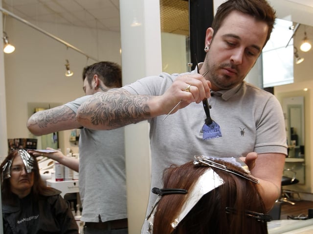 The winner of a makeover competition has her hair styled by Steve Robinson at Hensmans Salon in 2010.