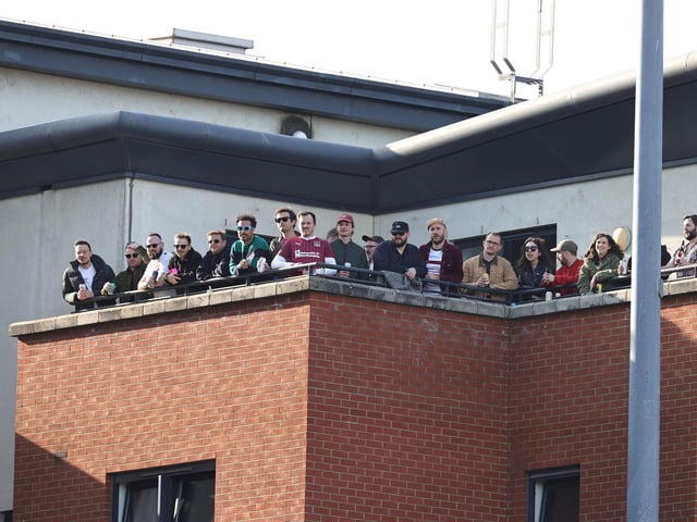 2025: A group of Northampton Town fans watch the game from a penthouse apartment overlooking the ground during the Sky Bet League One match between Leyton Orient FC and Northampton Town FC at Gaughan Group Stadium on March 08, 2025 in London, England. (Photo by Pete Norton/Getty Images)