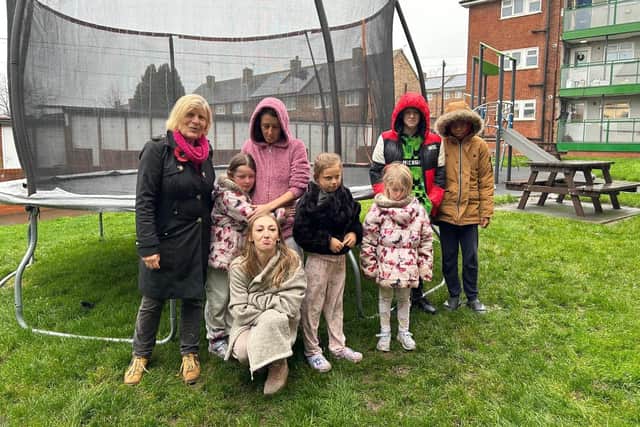 Councillor Sally Keeble (left) with children and parents at Kings Heath flats over the planned removal of a Christmas trampoline, which she says has left some in tears.