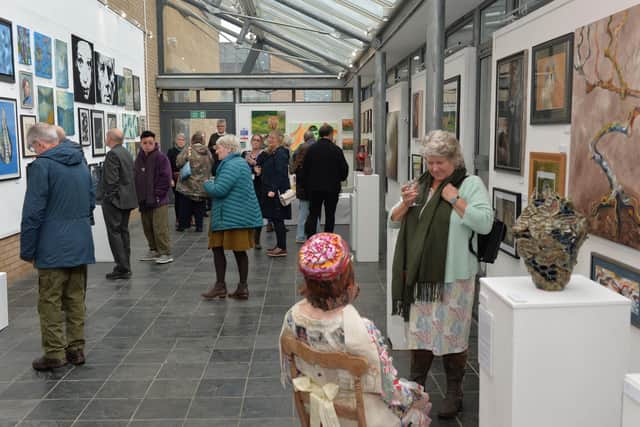A fine array of paintings, pottery and sculpture at The Heseltine Gallery's Open Exhibition, being viewed on launch day.