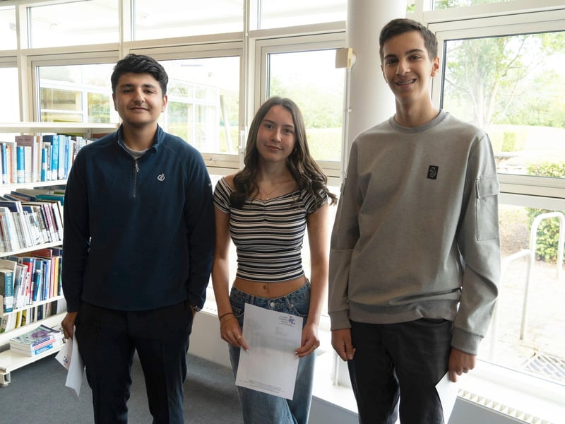 Students celebrate successful GCSE results.