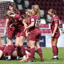 Kim Farrow of Northampton Town is mobbed by her team-mates as they celebrate during the FA Women's National League Division One Midlands match against Notts County at Sixfields.  (Photo by Pete Norton/Getty Images)