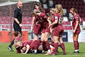 Kim Farrow of Northampton Town is mobbed by her team-mates as they celebrate during the FA Women's National League Division One Midlands match against Notts County at Sixfields.  (Photo by Pete Norton/Getty Images)