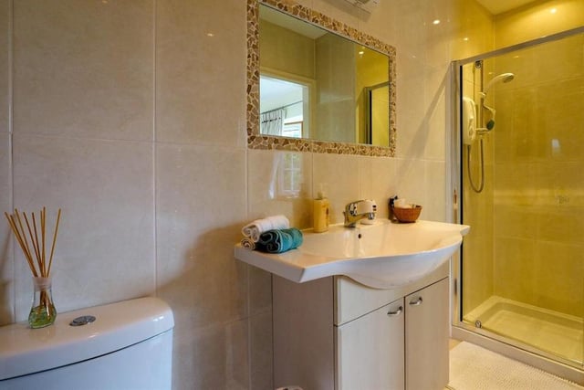 The third and fourth bedrooms at the £650,000 bungalow have access to this Jack and Jill en suite, which has underfloor heating. It comprises an enclosed shower, top-mounted sink with vanity unit, low-flush WC, tiled walls, tiled floor and a chrome heated towel-rail.