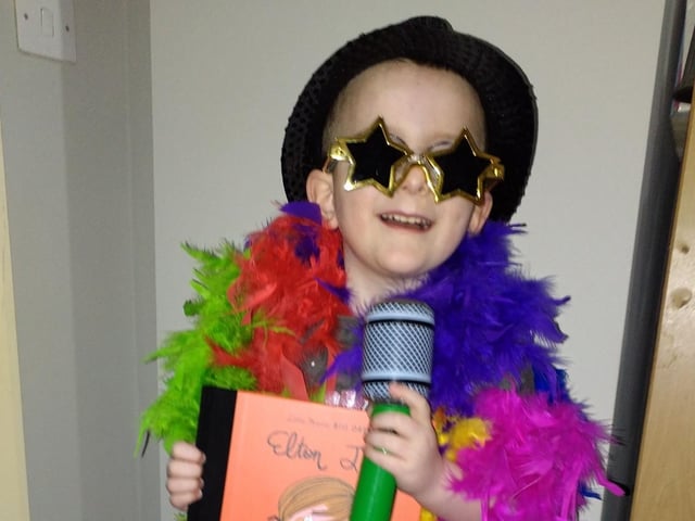 Harrison, aged five, as Elton John.