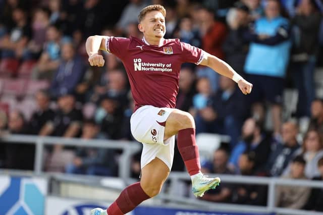 Sam Hoskins jumps for joy after slotting home an early penalty against Wycombe.