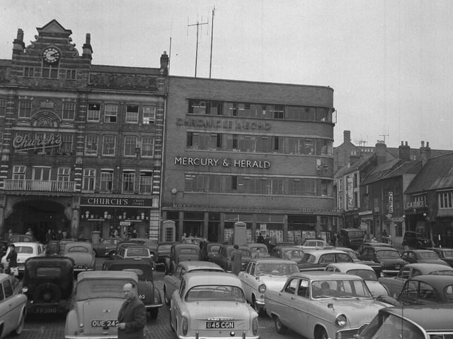 Northampton Market Square circ 1964 showing Chron building and Emporium Arcade, which was demolished in the 1970s. When there was no market, the square became a popular free car park.