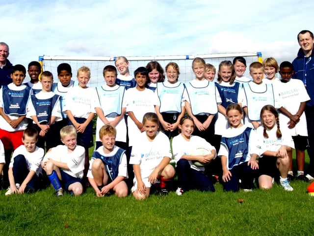 Queen Eleanor Primary School receive new kit and sports equipment from Barclays. Pic includes Paul Madeley, Sports Coordinator on right and Chair of Govenors Fred Watson on left.
