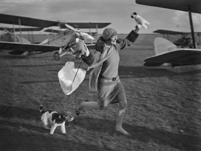 November 1929: The Honourable Mrs Chesterman retrieves the toy animals dropped by a parachute at a Northampton Aero Club meet. (Photo by Puttnam /Topical Press Agency/Hulton Archive/Getty Images)