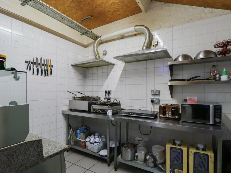 The building comes with a professional kitchen area, well-suited for a cafe or restaurant