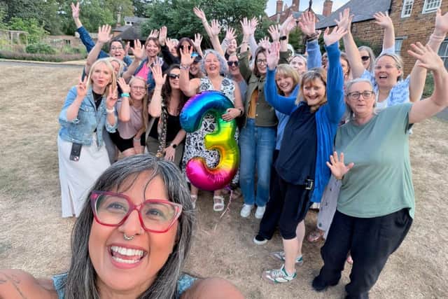 Helen Aluko, pictured holding the balloon, is the founder of a much-loved menopause meet up which recently celebrated its third anniversary at iconic landmark Delapré Abbey.
