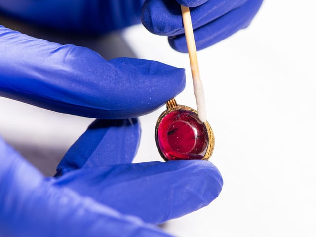 Cleaning garnet and gold pendant from Harpole Burial necklace
